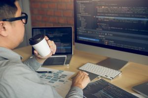 software engineer drinking coffee while working